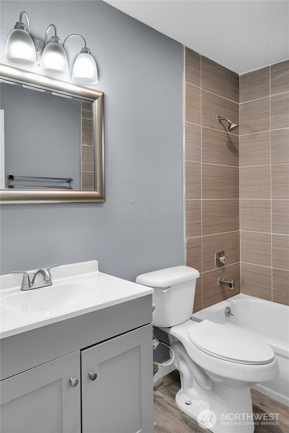 338 16th Avenue, Unit B Seattle, WA 98122 - Photo 7 of 7 a bathroom with a sink a toilet and mirror