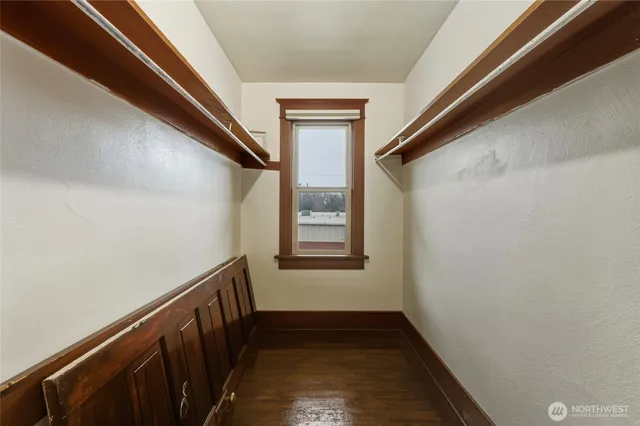 a bedroom with a bed and a lamp on table