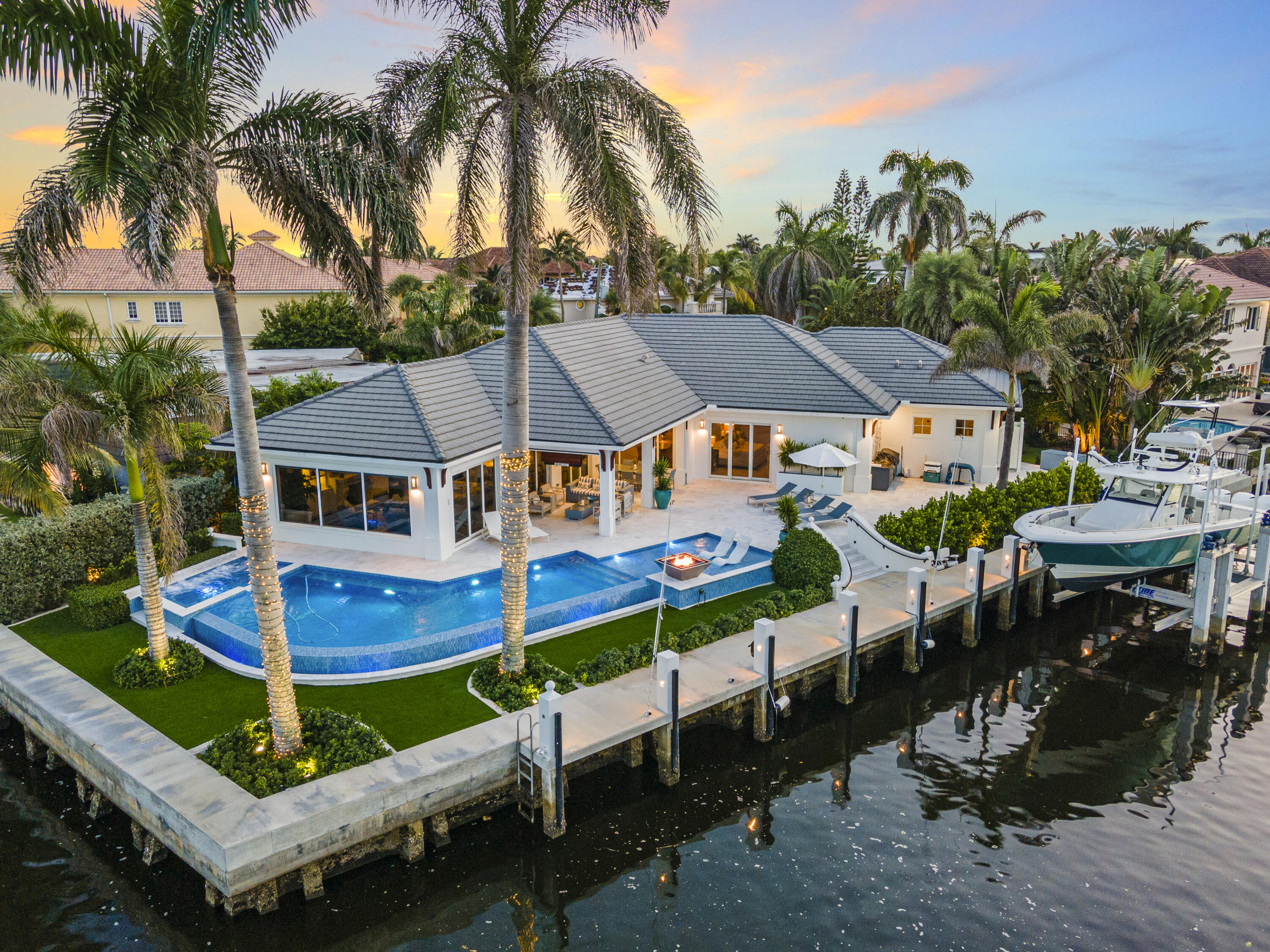 a view of house with outdoor space swimming pool and trees