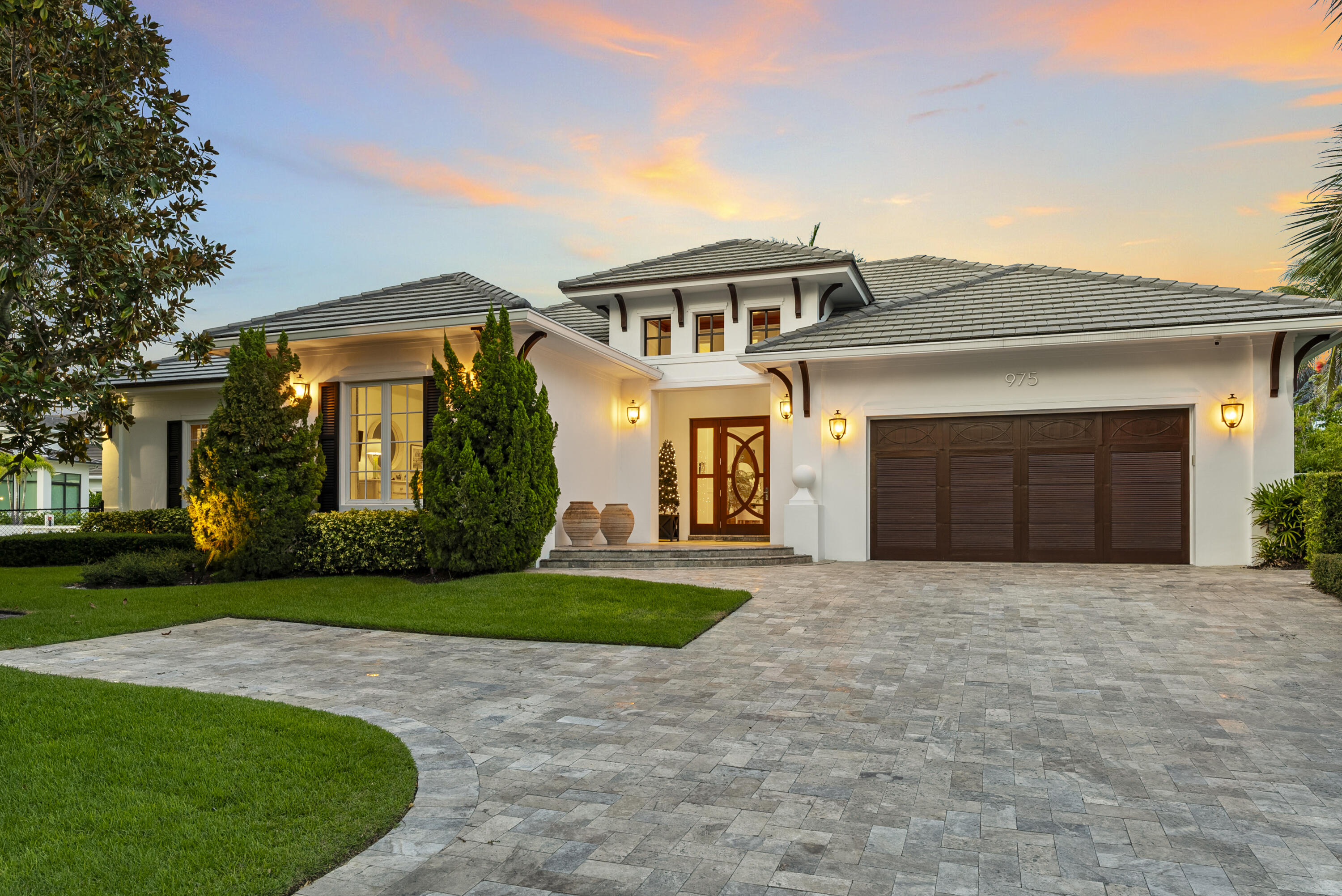975 Banyan Drive Delray Beach, FL 33483 - Photo 11 of 66 a front view of a house with a yard and garage