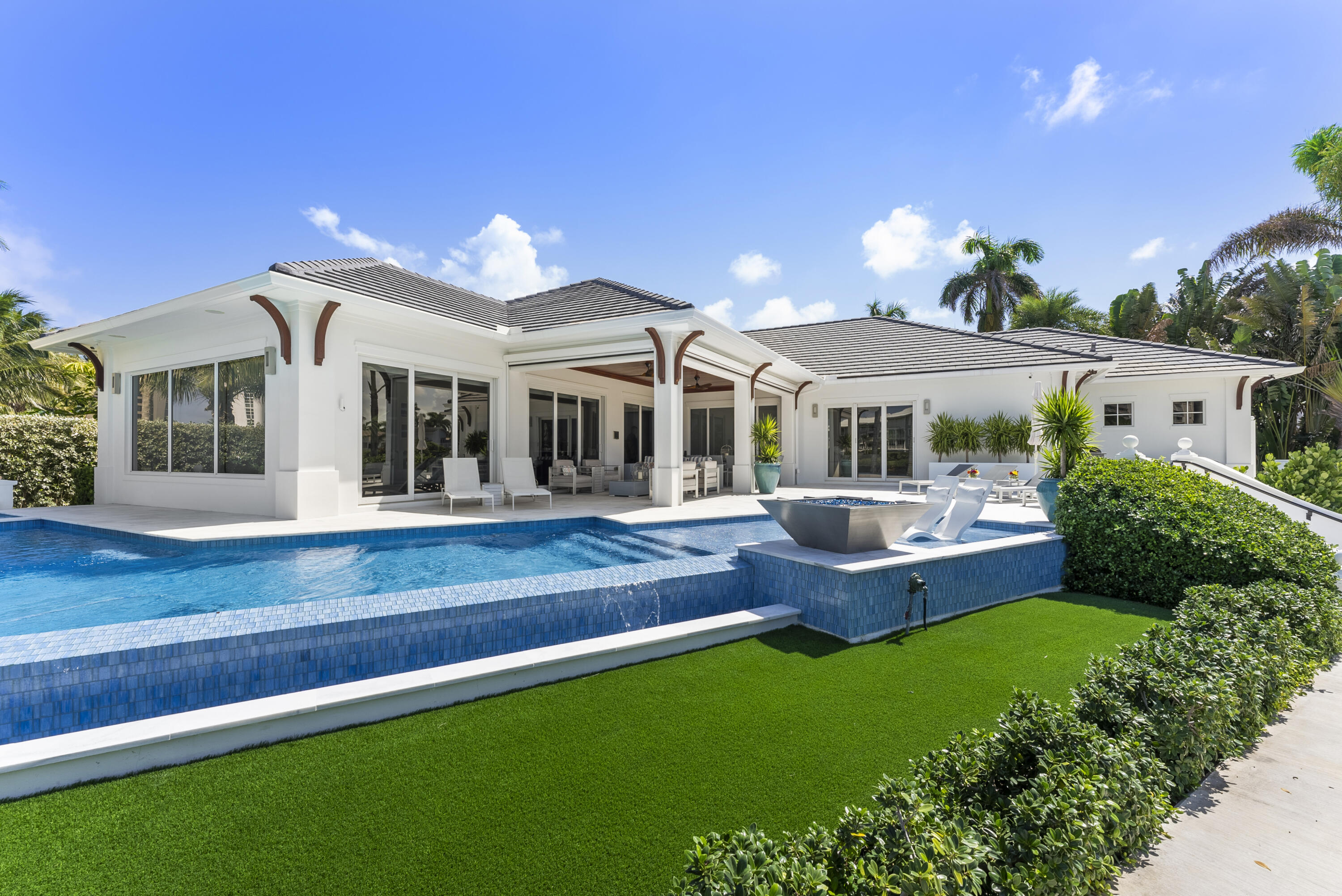 975 Banyan Drive Delray Beach, FL 33483 - Photo 22 of 66 a front view of a house with a yard