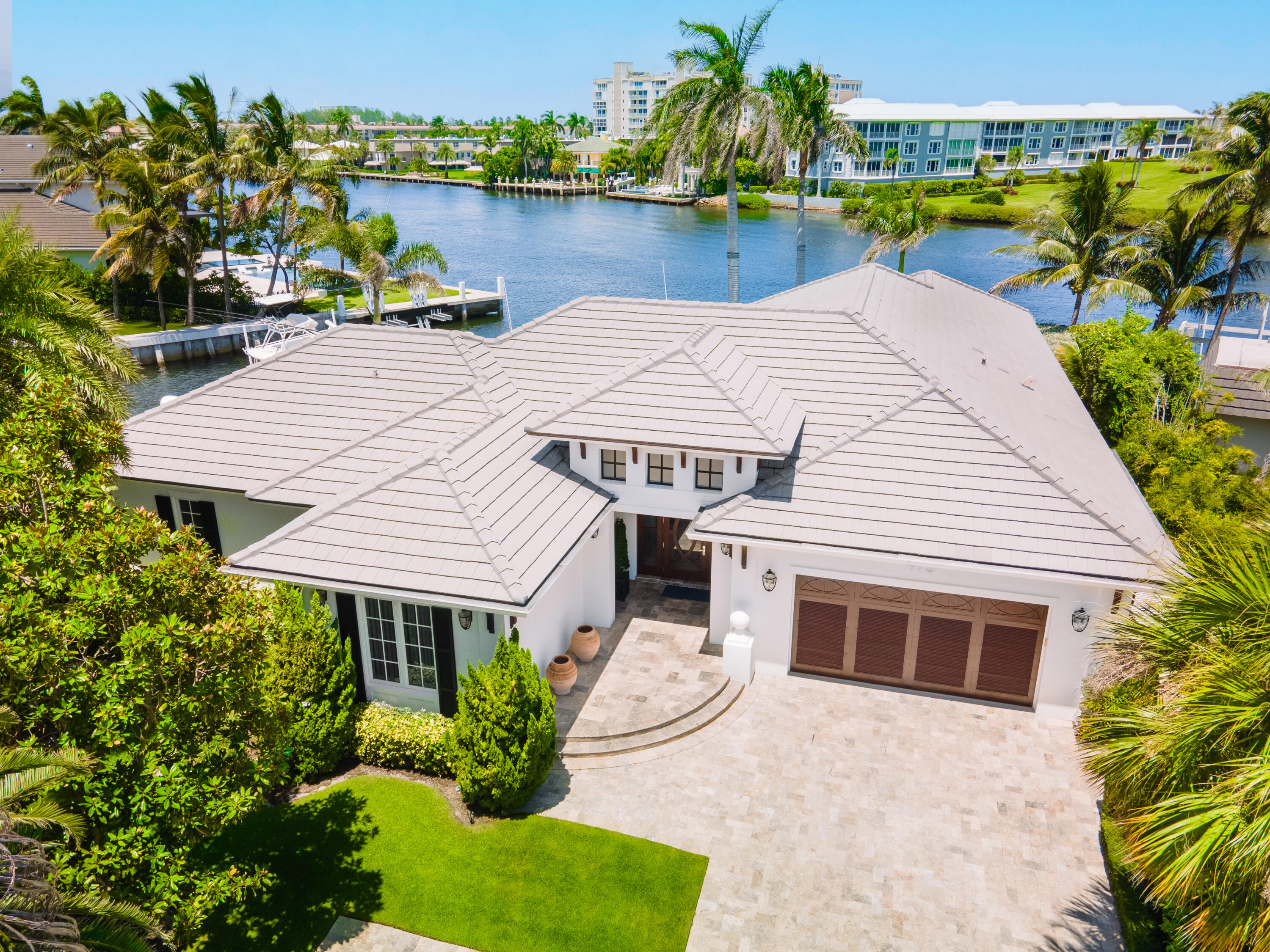 975 Banyan Drive Delray Beach, FL 33483 - Photo 66 of 66 a view of a house with pool and chairs next to a yard