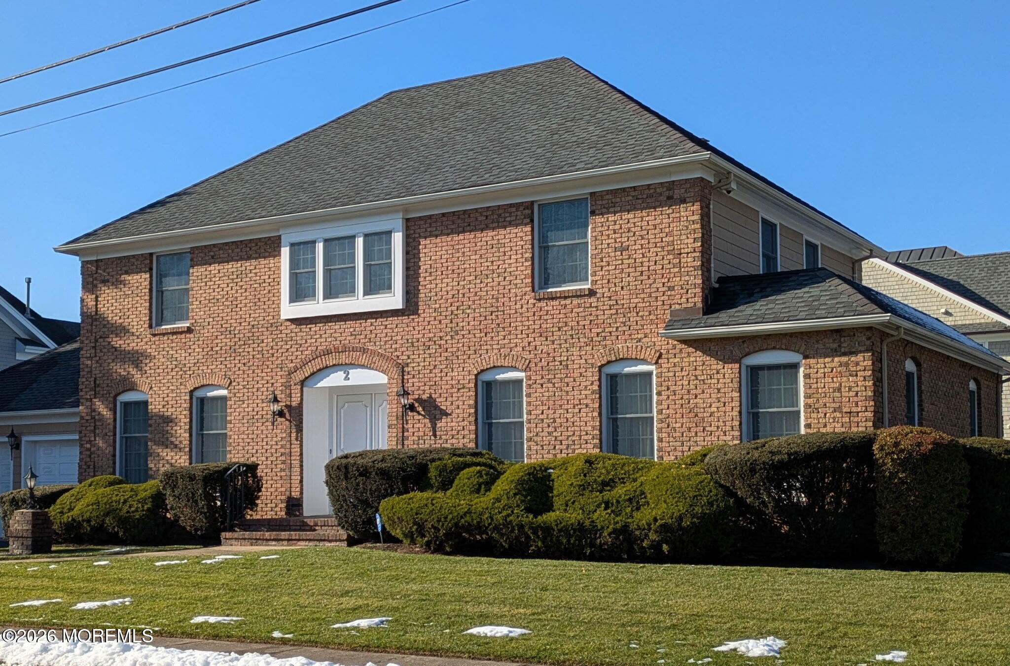a front view of house with yard and green space