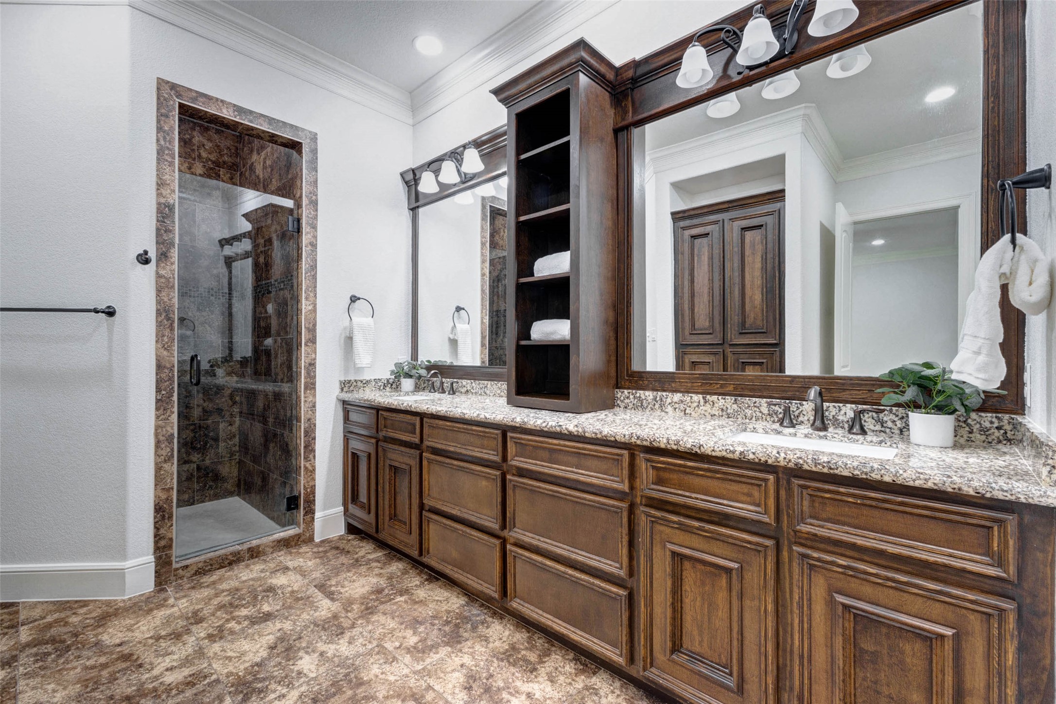 5327 Whitmore Fulshear, TX 77441 - Photo 25 of 50 The spa-inspired primary bath features an expansive dual-sink vanity with granite countertops, abundant cabinetry, and extensive storage.
