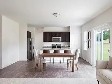 a view of a dining room with furniture and wooden floor