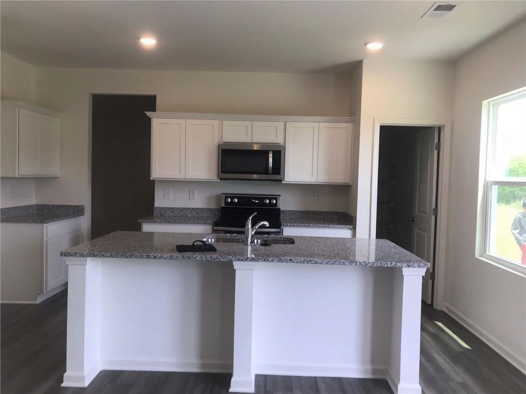 166 Verona Drive Northwest Cartersville, GA 30120 - Photo 6 of 13 a kitchen with a refrigerator and a stove top oven