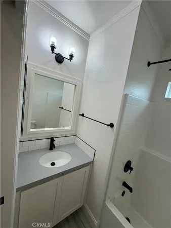 a bathroom with a sink and mirror