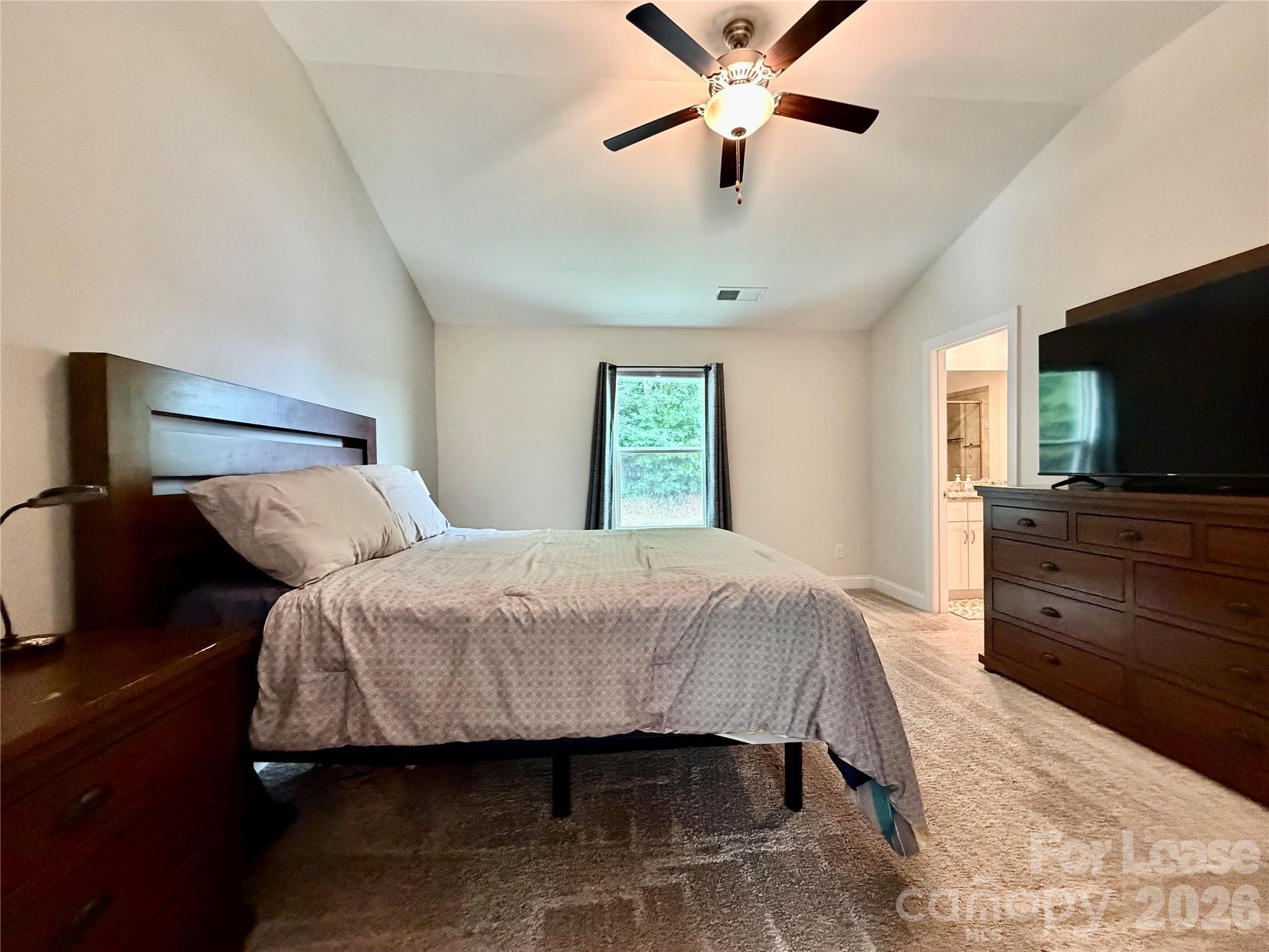 1220 Pecan Ridge Road Fort Mill, SC 29715 - Photo 11 of 25 a bedroom with a bed and a flat screen tv