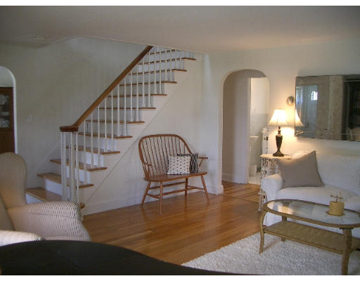 25 Hambly Road Tiverton, RI 02878 - Photo 7 of 8 a living room with couches and a dining table with wooden floor