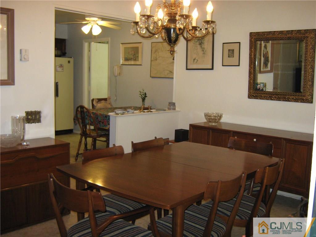 742 B Pompton Road Monroe Township, NJ 08831 - Photo 7 of 11 a view of a dining room with furniture and wooden floor