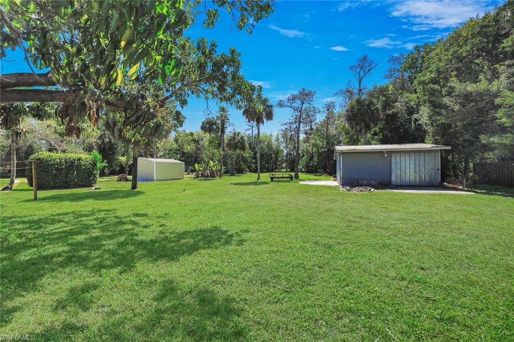 5290 Cypress Lane Naples, FL 34113 - Photo 2 of 39 a view of a backyard with a garden
