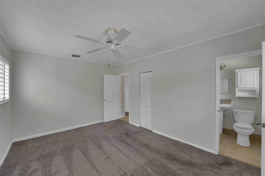2725 Southeast 5th Court Pompano Beach, FL 33062 - Photo 17 of 37 a view of a room with wooden floor and a ceiling fan