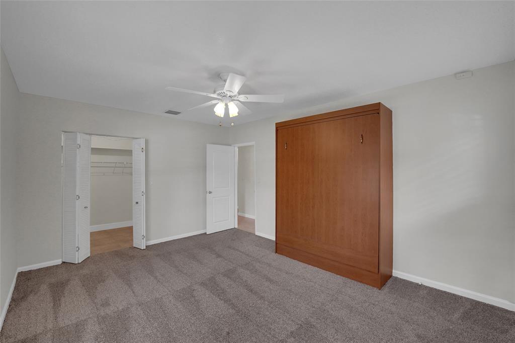 2725 Southeast 5th Court Pompano Beach, FL 33062 - Photo 20 of 37 an empty room with windows and fan