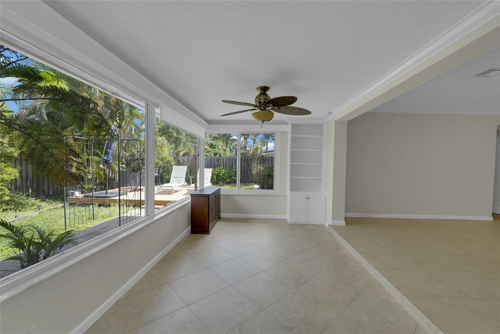 2725 Southeast 5th Court Pompano Beach, FL 33062 - Photo 26 of 37 a large living room with a large window and a fireplace