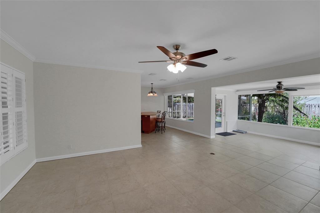 2725 Southeast 5th Court Pompano Beach, FL 33062 - Photo 6 of 37 an empty room with entrance and windows