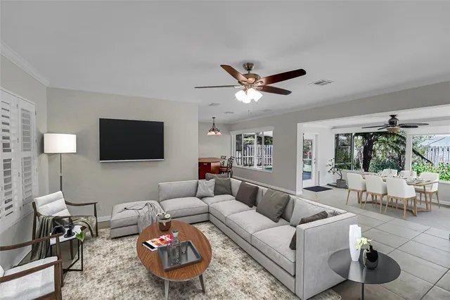 a dining room with furniture a chandelier and window