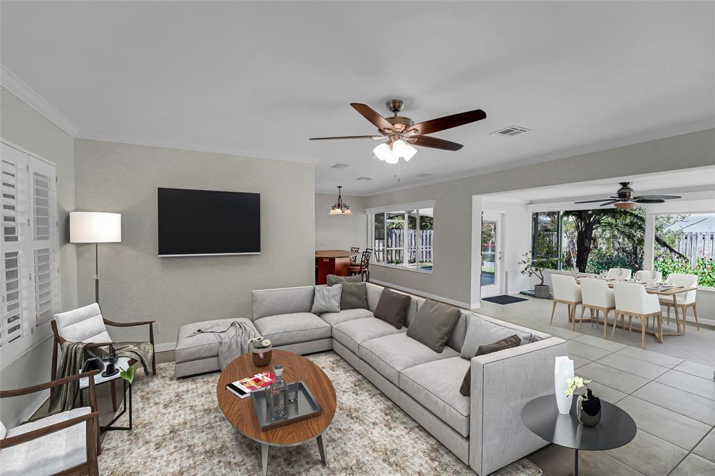 2725 Southeast 5th Court Pompano Beach, FL 33062 - Photo 7 of 37 a living room with furniture a flat screen tv and a large window