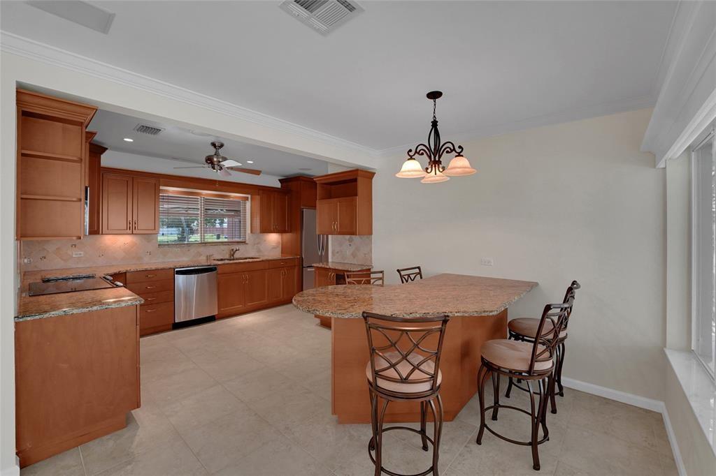2725 Southeast 5th Court Pompano Beach, FL 33062 - Photo 8 of 37 a dining room with furniture a chandelier and window