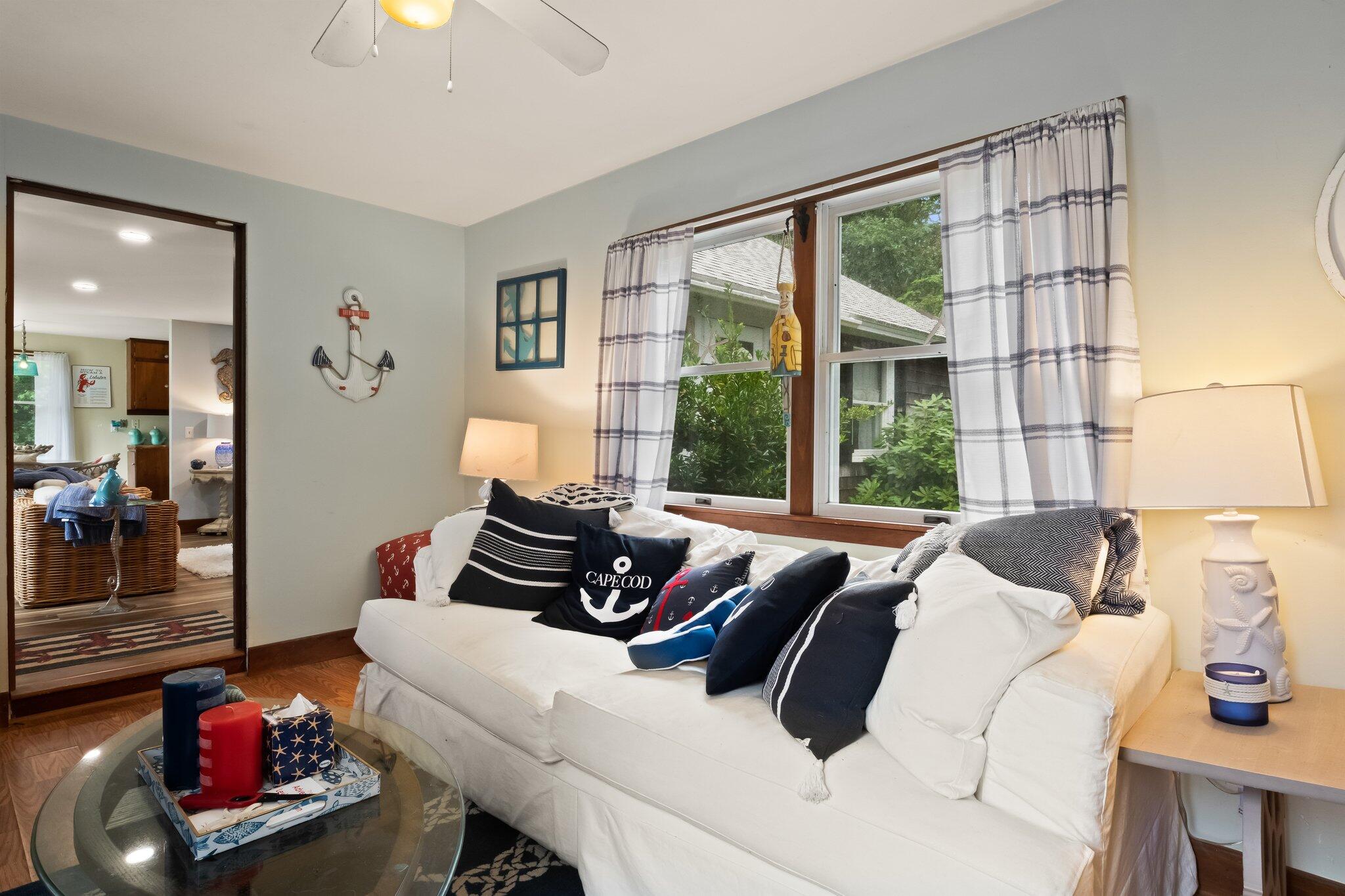 45 Designers Road Wellfleet, MA 02667 - Photo 18 of 84 a bedroom with furniture and a large window