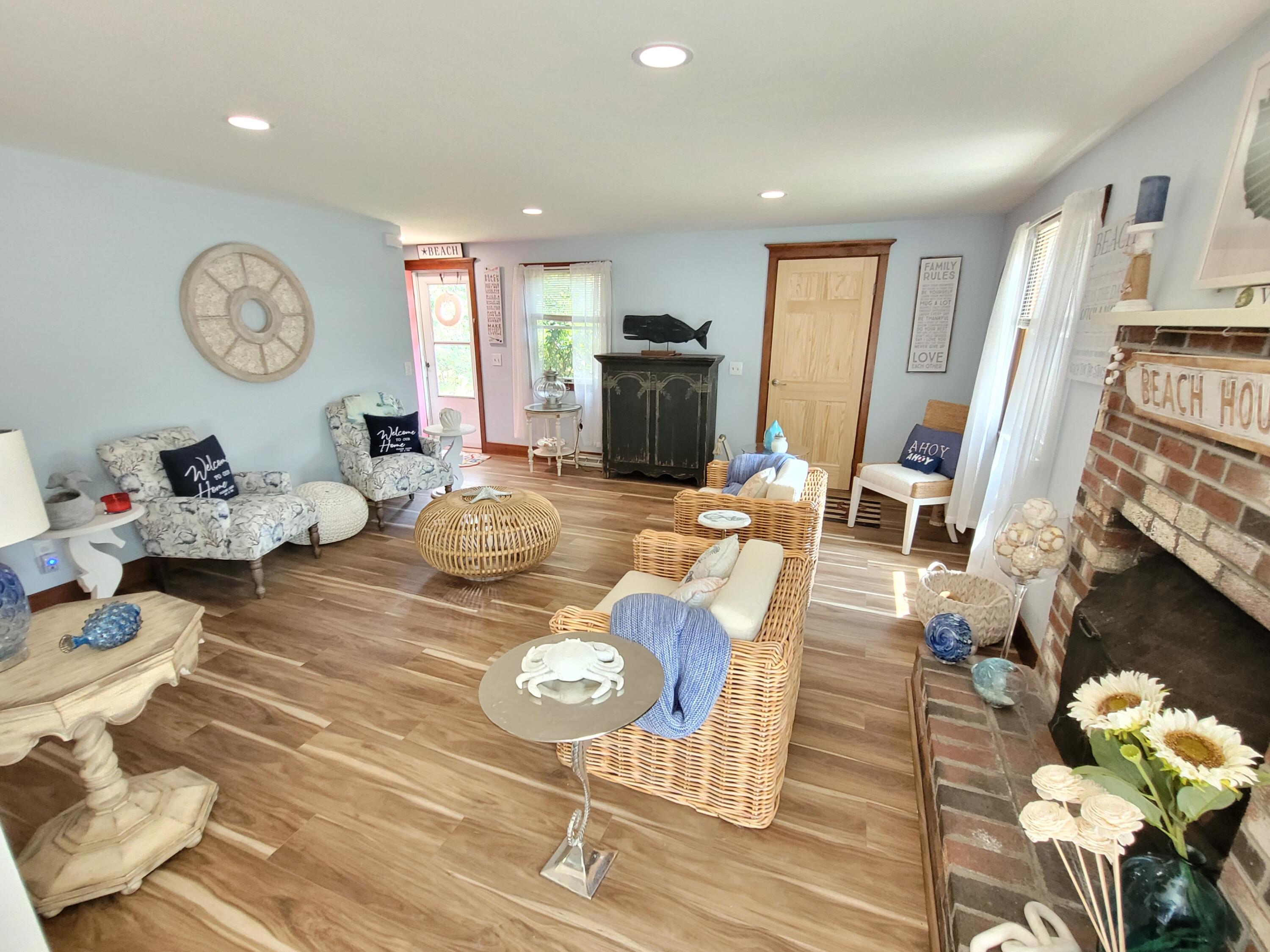 45 Designers Road Wellfleet, MA 02667 - Photo 20 of 84 a living room with fireplace furniture and a wooden floor