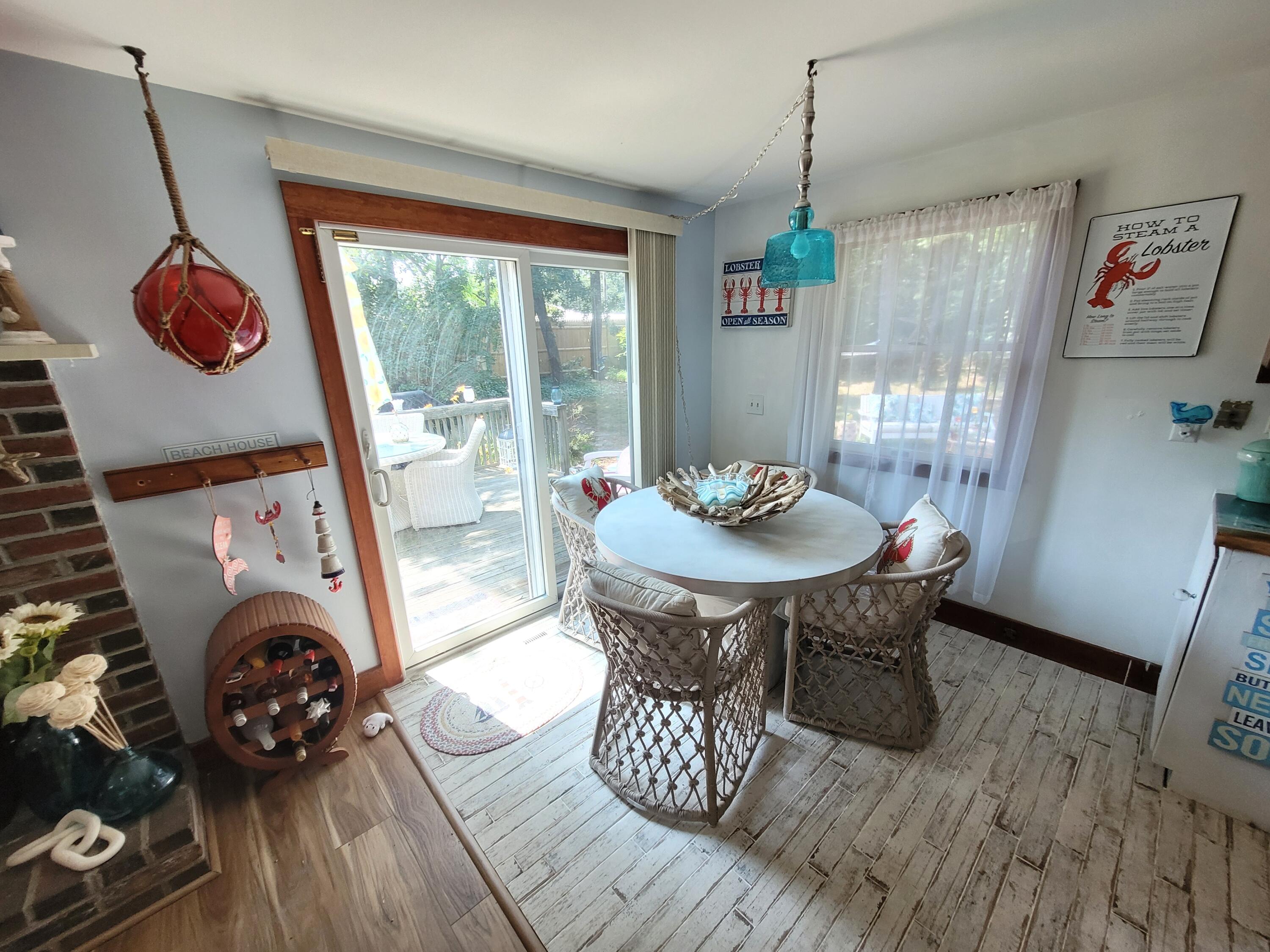 45 Designers Road Wellfleet, MA 02667 - Photo 21 of 84 a dining room with furniture garden view and a chandelier
