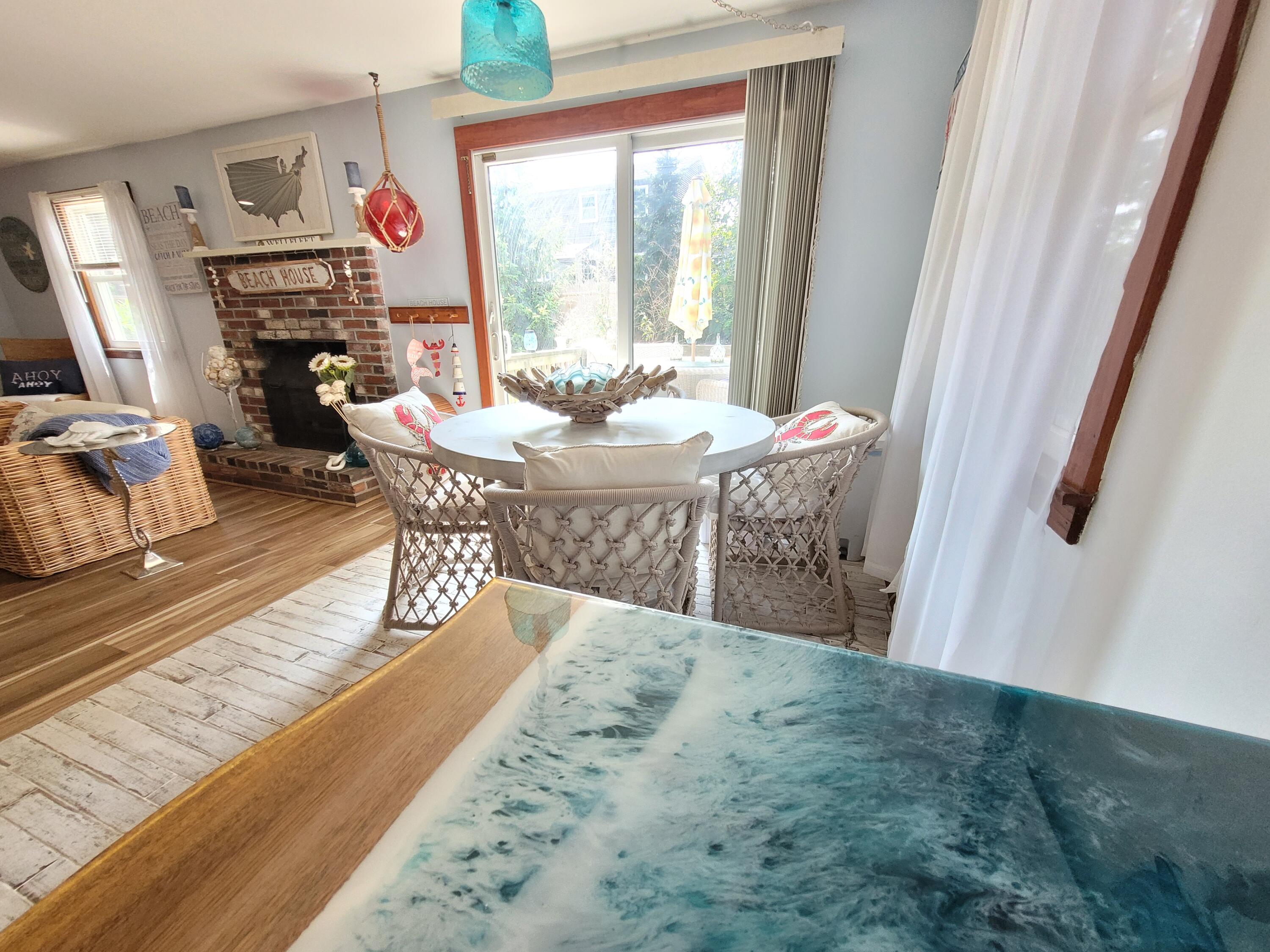45 Designers Road Wellfleet, MA 02667 - Photo 27 of 84 a view of a dining room with furniture window and wooden floor