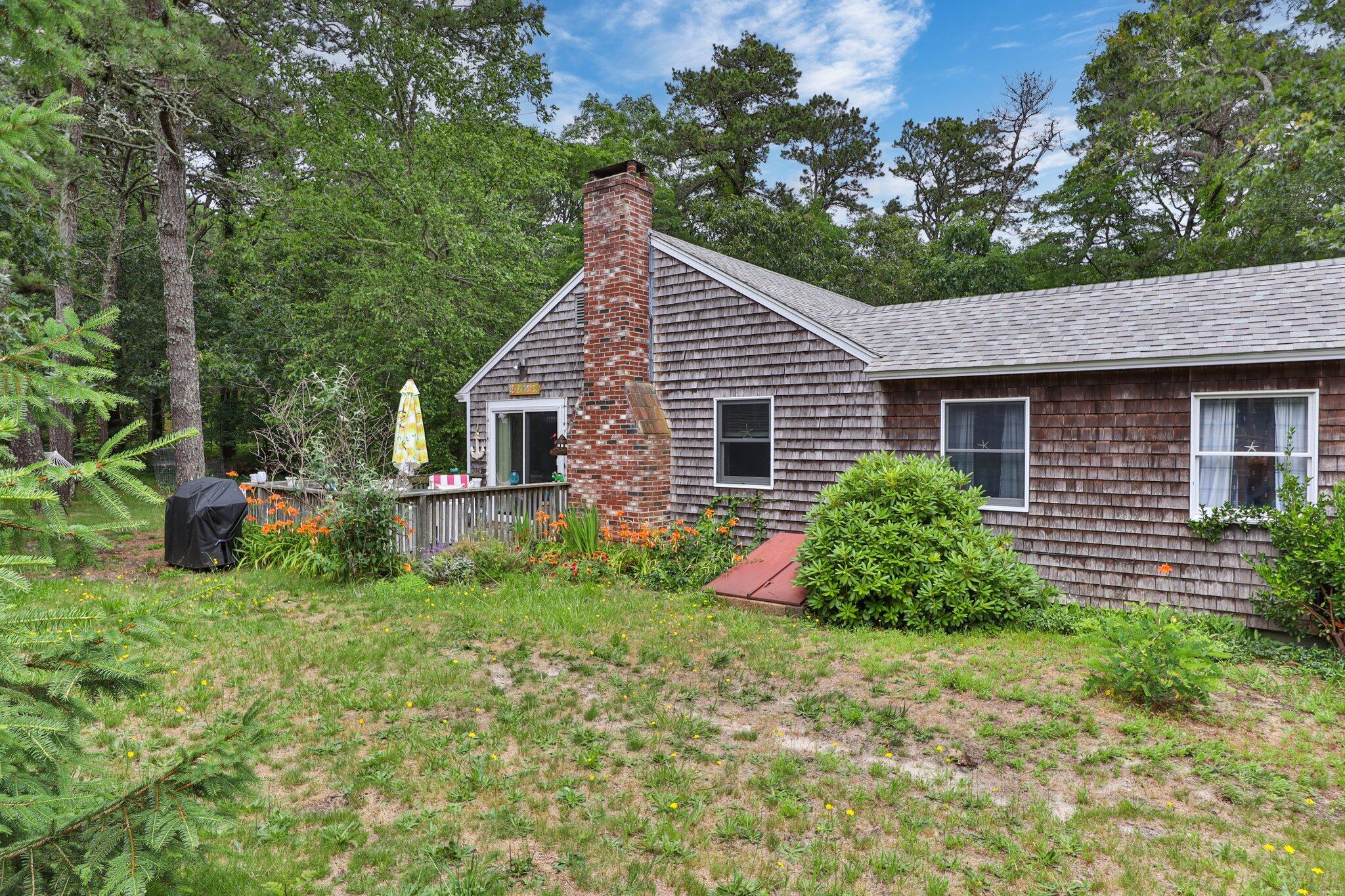45 Designers Road Wellfleet, MA 02667 - Photo 3 of 84 a view of a house with a yard and potted plants