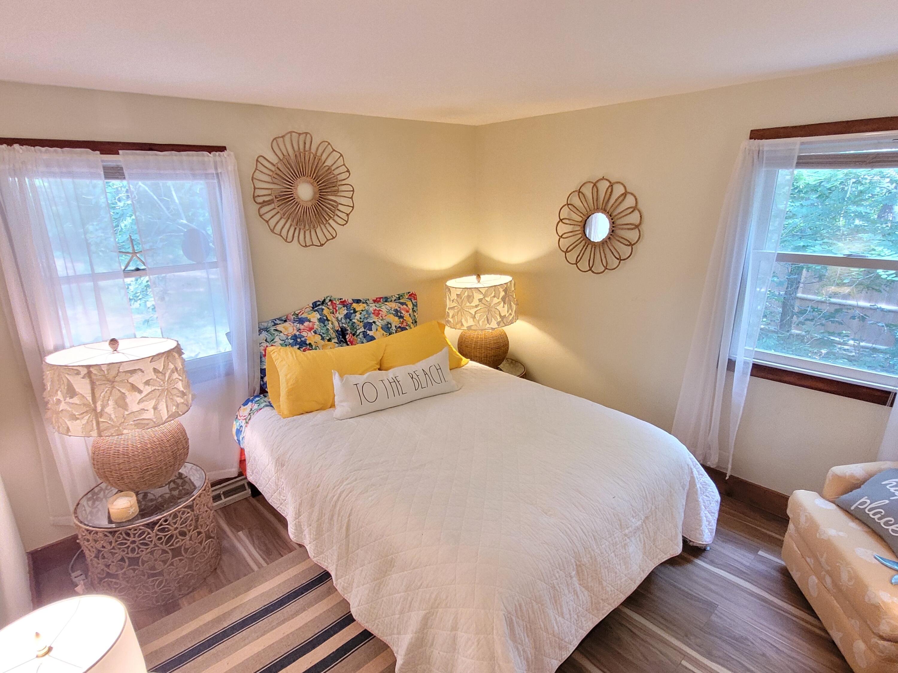 45 Designers Road Wellfleet, MA 02667 - Photo 39 of 84 a bedroom with a bed and dresser with wooden floor