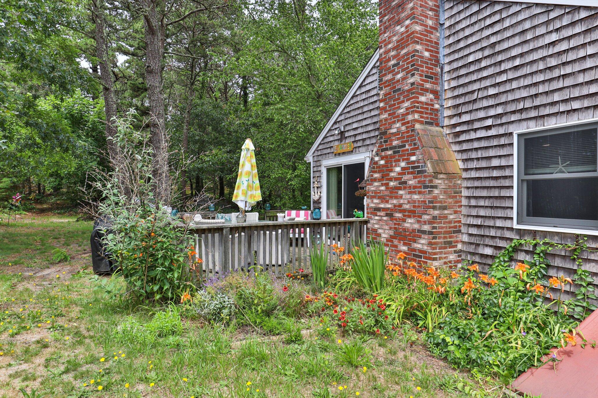 45 Designers Road Wellfleet, MA 02667 - Photo 56 of 84 a view of a house with a yard and a garden