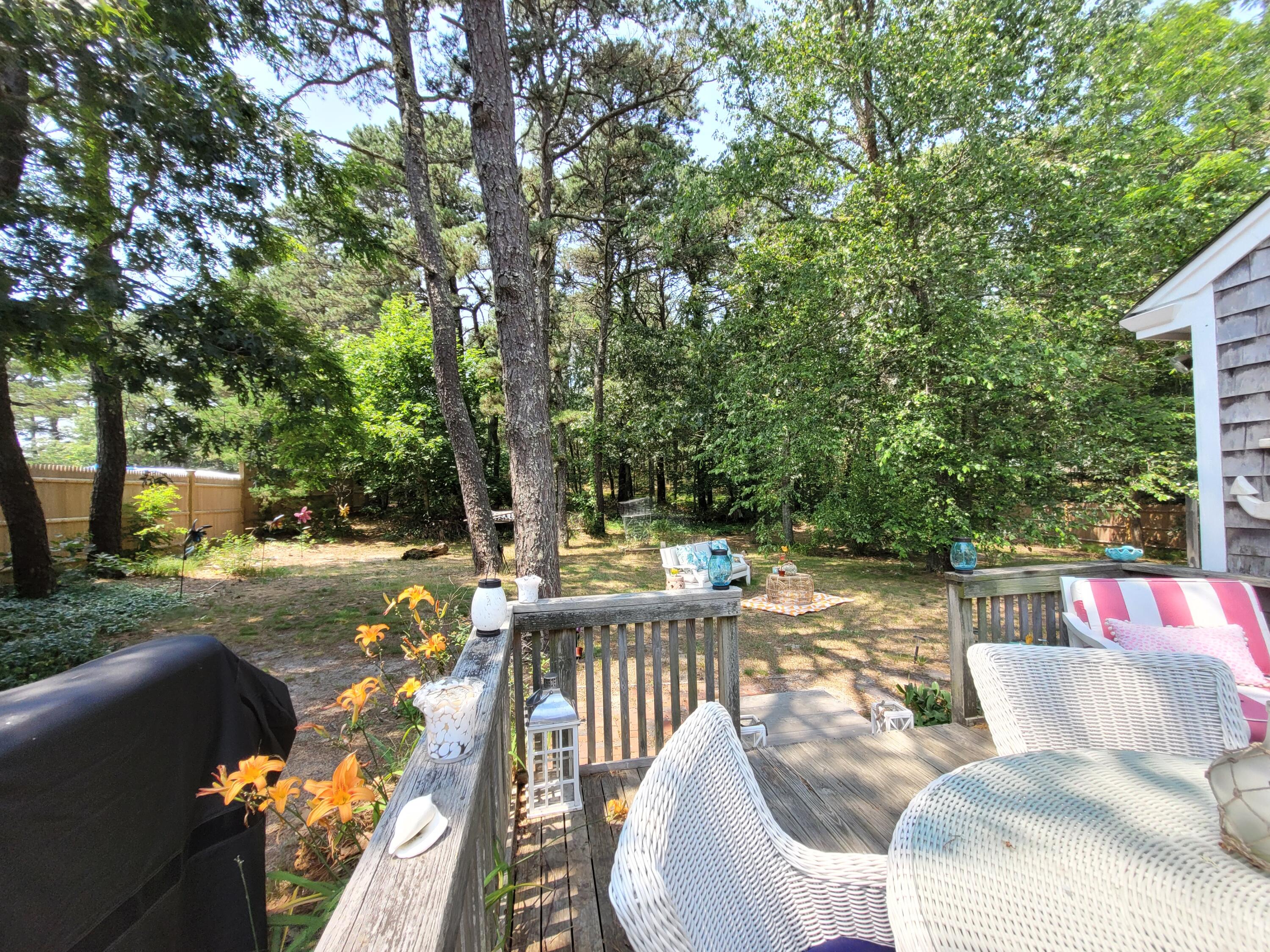 45 Designers Road Wellfleet, MA 02667 - Photo 58 of 84 a view of a patio with couches table and chairs and potted plants
