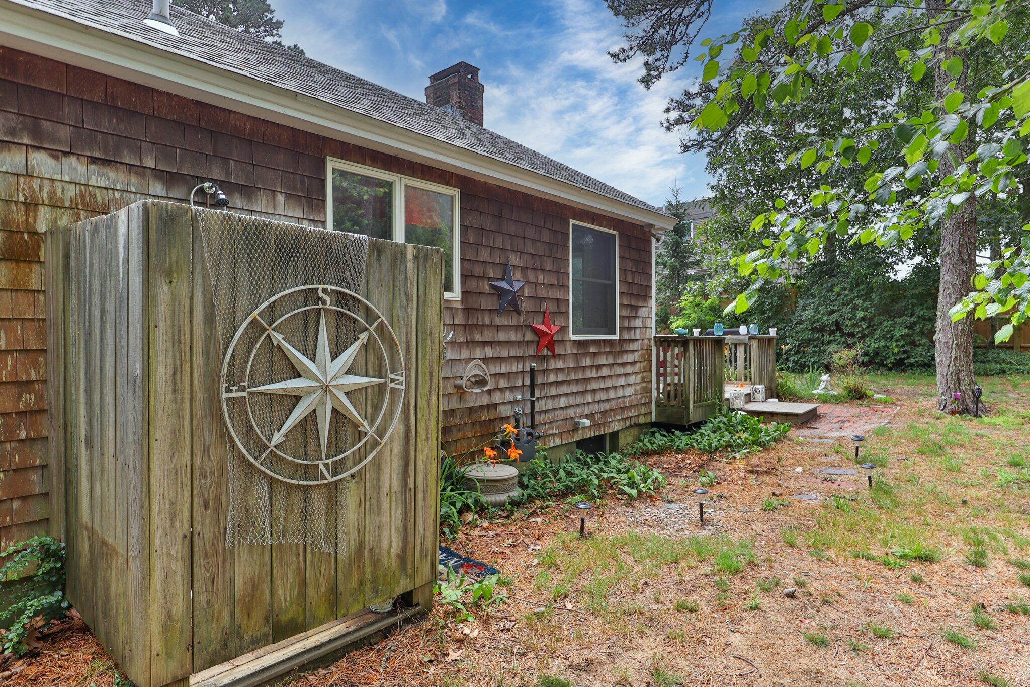 45 Designers Road Wellfleet, MA 02667 - Photo 64 of 84 a view of a house with a small yard and wooden fence