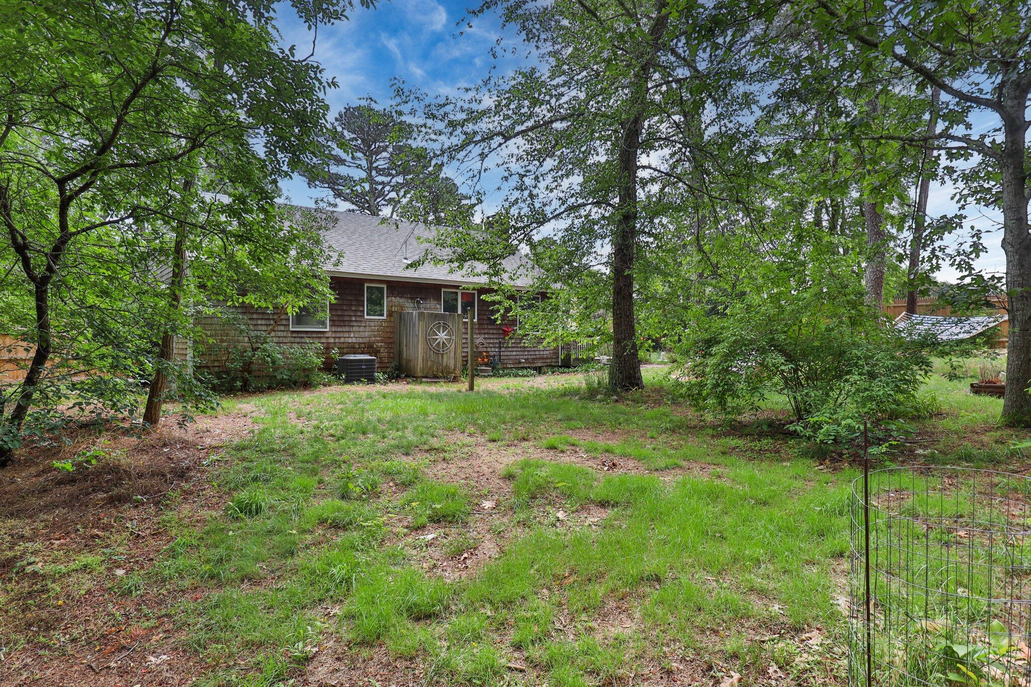 45 Designers Road Wellfleet, MA 02667 - Photo 65 of 84 a view of a house with yard and a tree