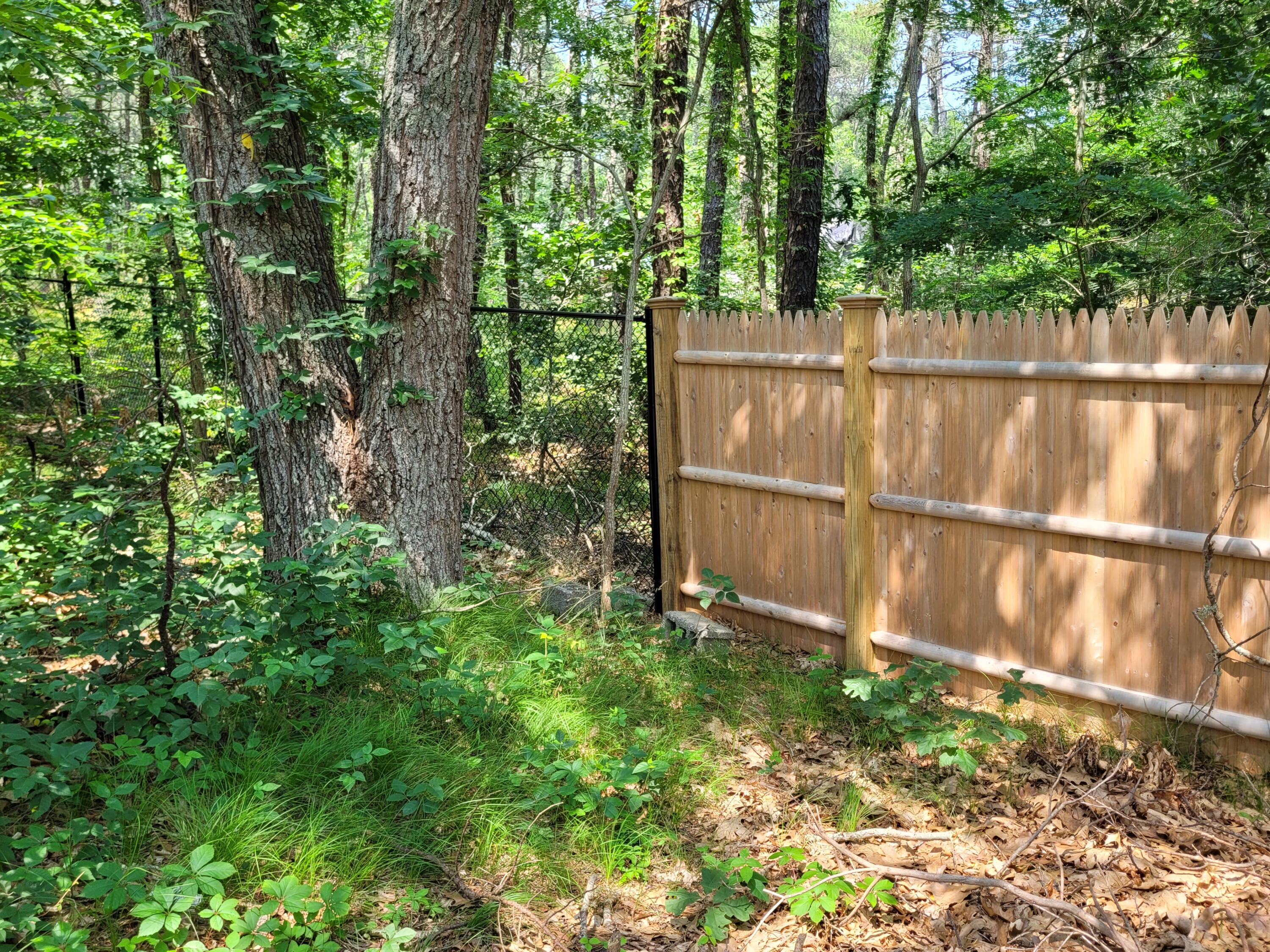 45 Designers Road Wellfleet, MA 02667 - Photo 71 of 84 a view of backyard with green space and wooden fence