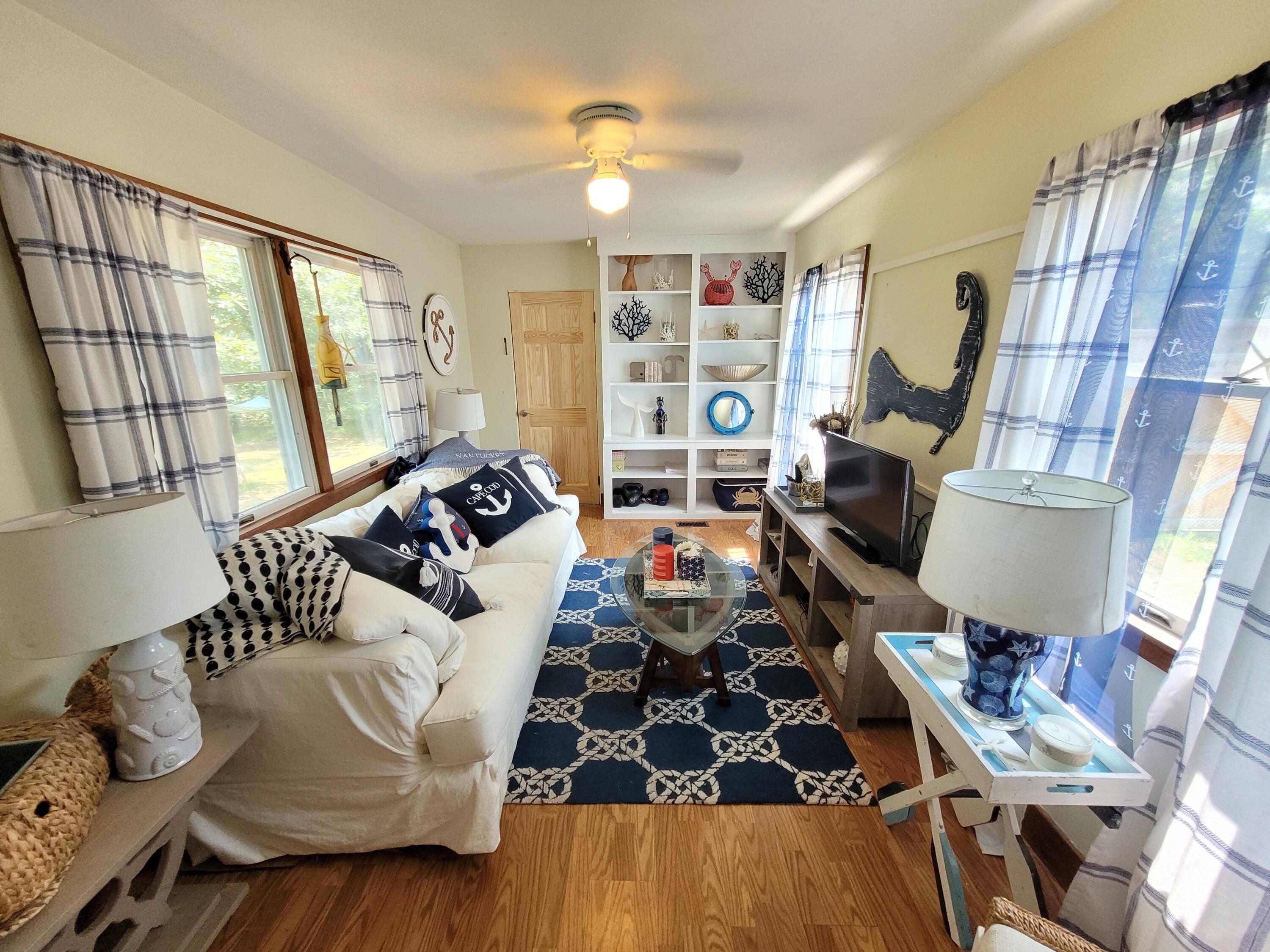45 Designers Road Wellfleet, MA 02667 - Photo 8 of 84 a living room with furniture and a large window
