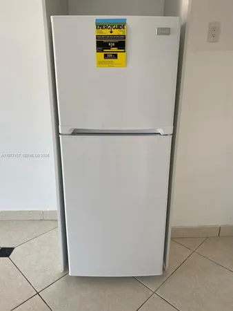 a white refrigerator freezer sitting in a kitchen