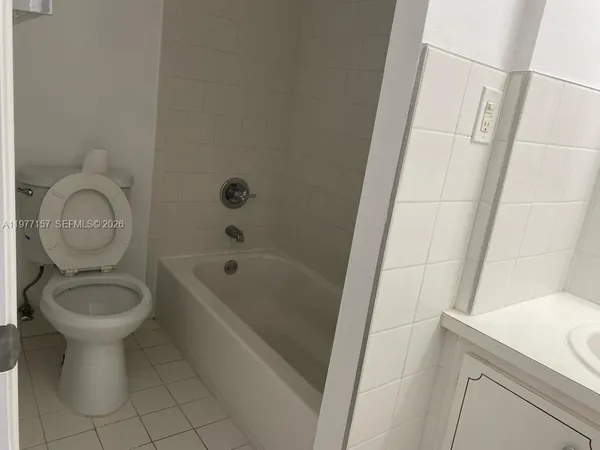a bathroom with a sink a toilet and bathtub