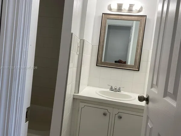 a bathroom with a sink and a mirror