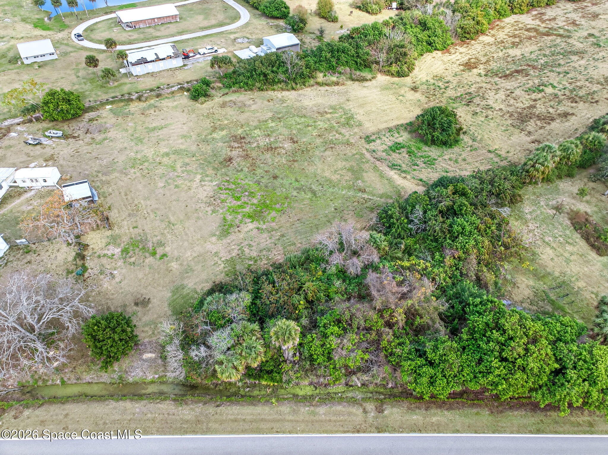 3825 Turtle Mound Road Melbourne, FL 32934 - Photo 15 of 19 a view of a yard with plants and a bench