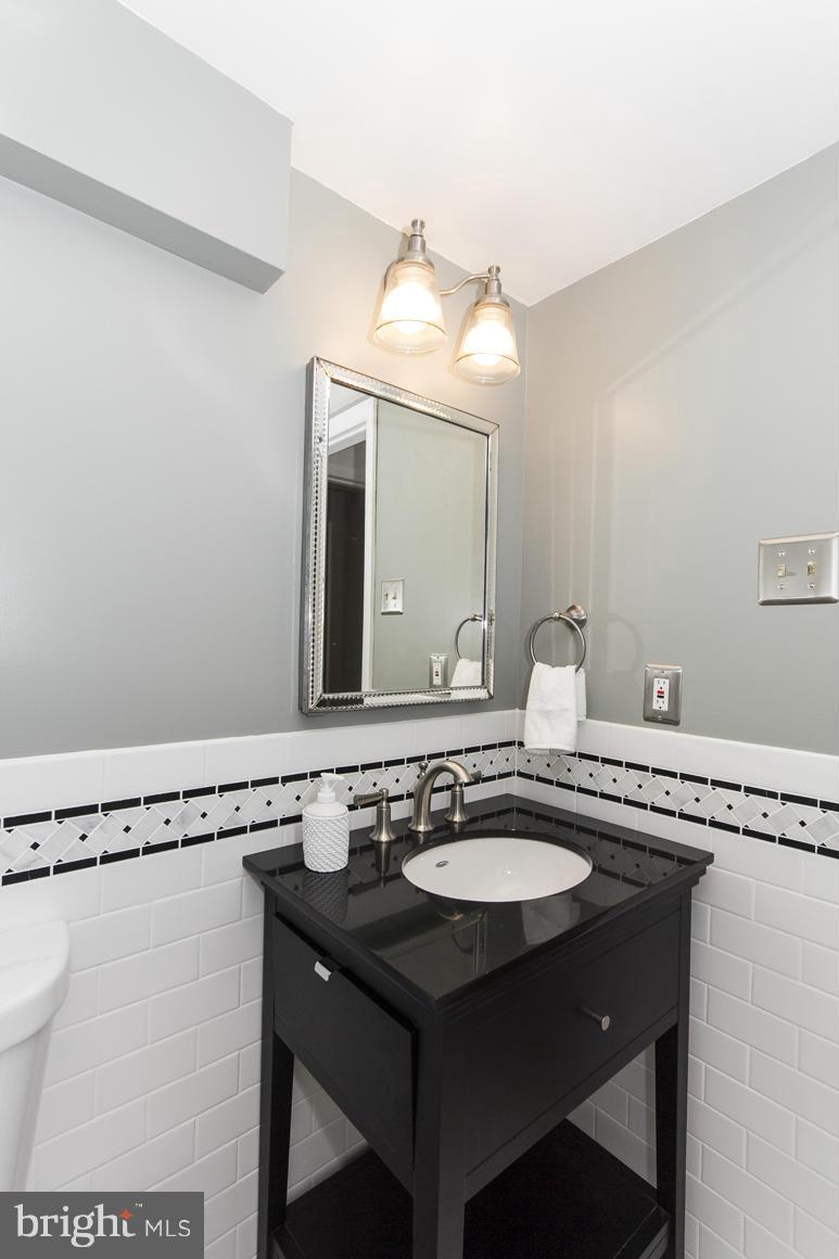 121 Cross Keys Road, Unit A Baltimore, MD 21210 - Photo 13 of 24 a bathroom with a sink and a mirror