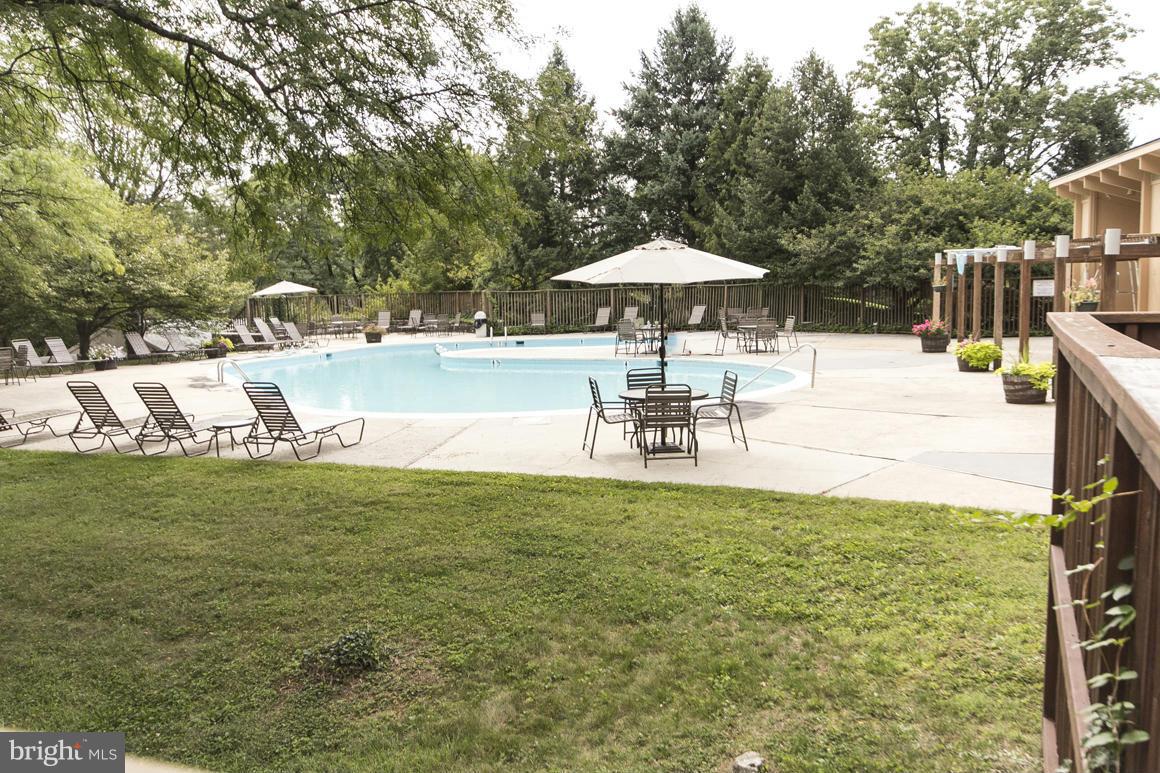 121 Cross Keys Road, Unit A Baltimore, MD 21210 - Photo 20 of 24 a swimming pool with outdoor seating and yard