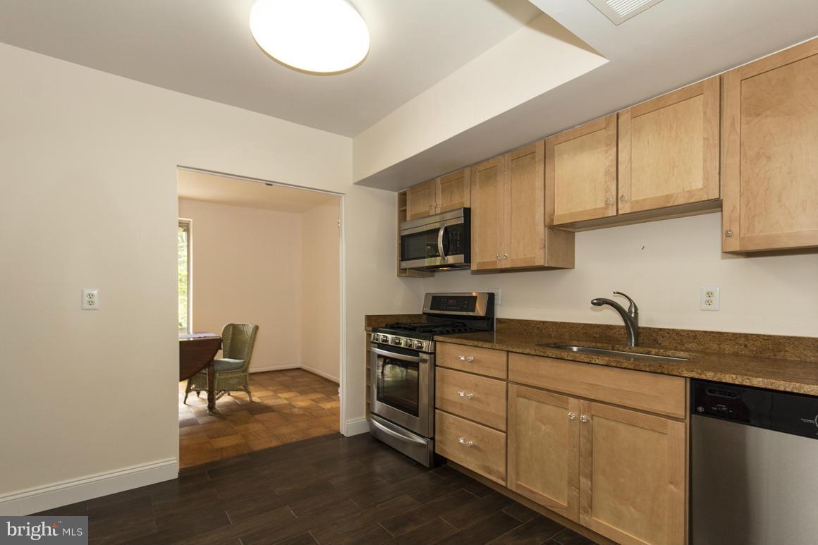 121 Cross Keys Road, Unit A Baltimore, MD 21210 - Photo 3 of 24 a kitchen with sink cabinets and appliances