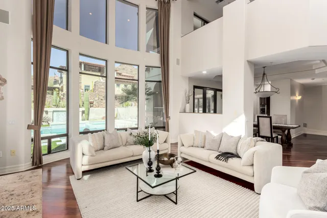 a living room with furniture a large window and a flat screen tv