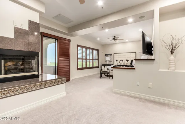 a bedroom with a bed a window and a ceiling fan