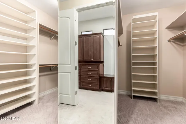 a bathroom with a granite countertop sink a toilet a mirror a vanity and shower