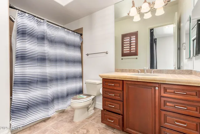 a living room with furniture and a ceiling fan