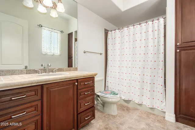 a view of a house with a yard and potted plants