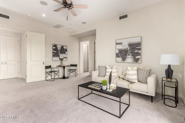 a view of a patio with couches and table and chairs with wooden fence