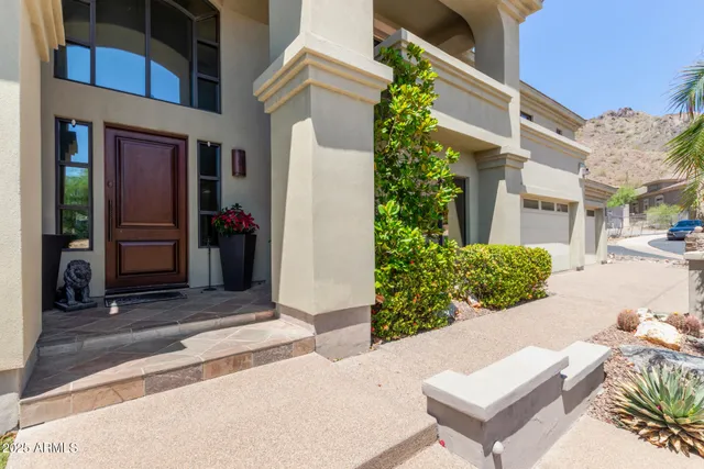 a living room with furniture fireplace and a large window
