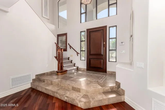 a living room with furniture and a large mirror