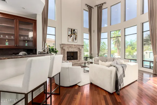 a living room with furniture and floor to ceiling windows
